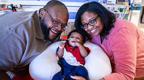 couple holding baby in NICU supported by smart giving donations 