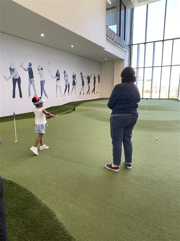 Child learning how to play golf at PGA Cares [2]